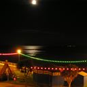 Moon and reflection over the swingboats and roundabout from Channel View